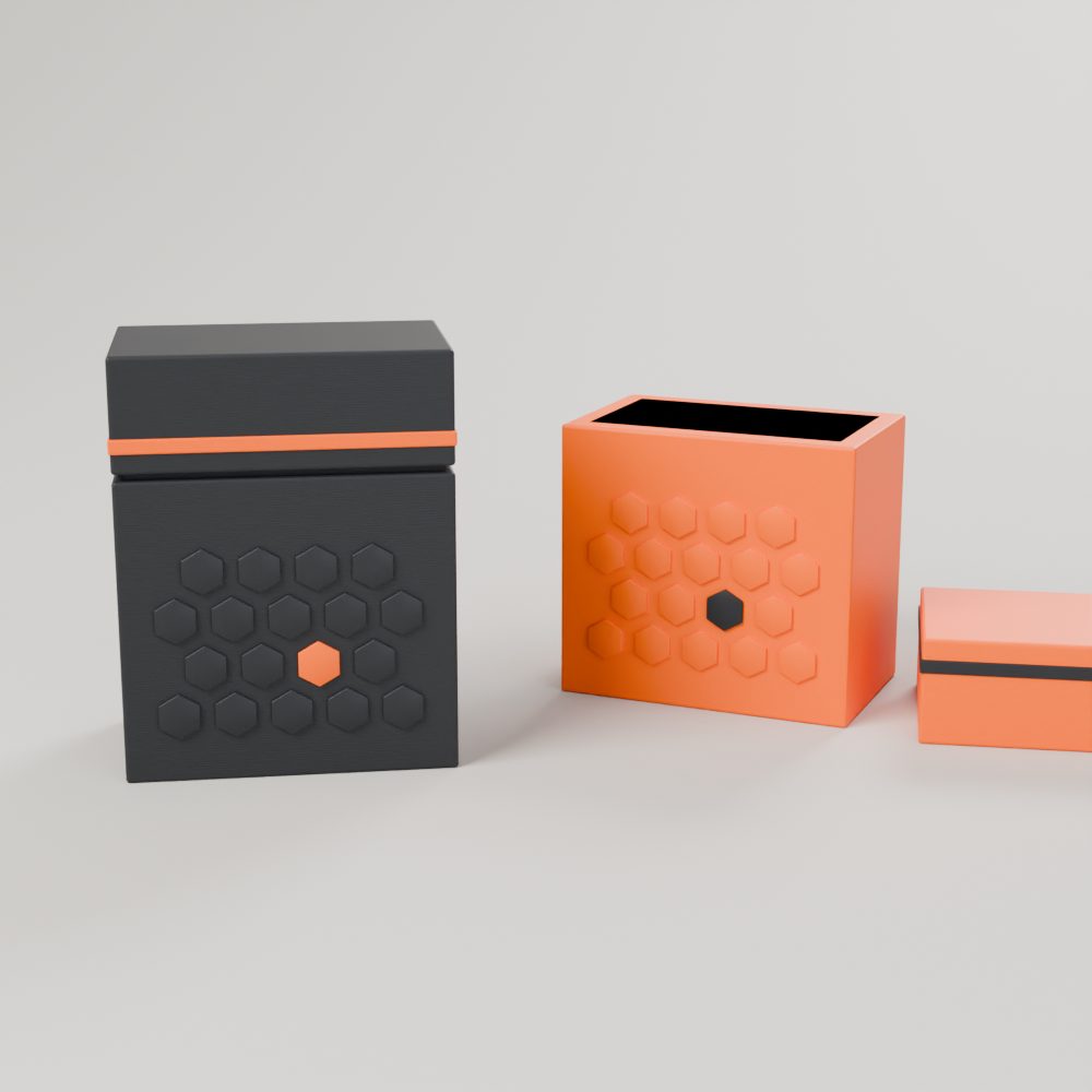 Charcoal 3D-printed deck box with an orange band next to an open orange deck box holding sleeved cards