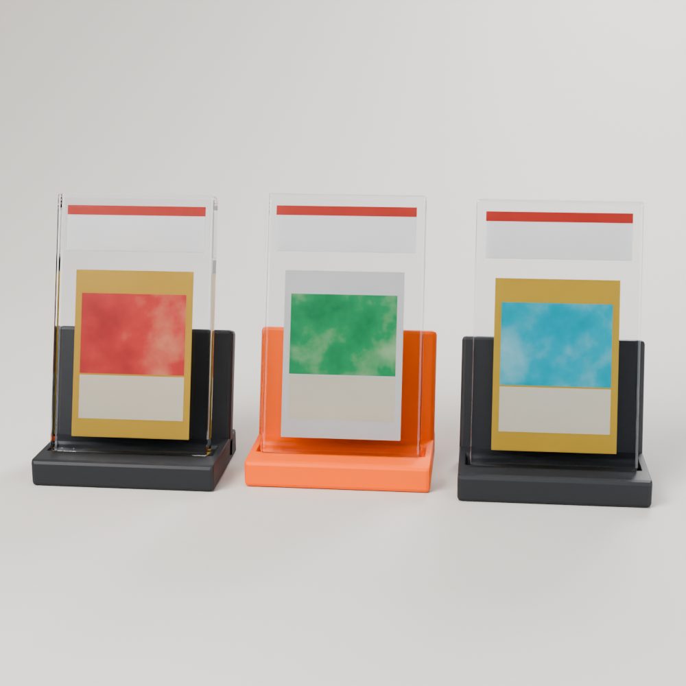 Three 3D-printed stands in charcoal and orange each holding a graded card slab